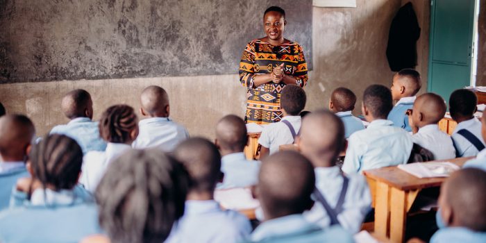 alt="Der Kampf des Vergebens, Compassion Deutschland, Eine Lehrerin steht vor der Klasse und spricht zu ihren Schülern"